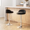 Pair of Artiss black PU leather gas lift bar stools near a white modern kitchen counter