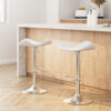 Artiss white leather gas lift bar stools 2-pack with chrome bases arranged neatly against a modern kitchen island bench.