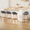 Artiss Dalvey Grey Linen Wooden Bar Stools set of four arranged by a modern breakfast bar