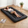 Giselle Bedding 10cm Japanese Floor Mattress unrolled as a guest bed in a modern room