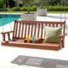 Gardeon 2 seater outdoor wooden swing chair bench teak suspended on a modern timber veranda.