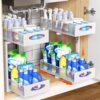 Carla Home 2-pack under sink organizer in white steel holding cleaning supplies inside a kitchen cabinet.