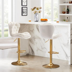 Serenità set of 2 swivel velvet bar stools ivory gold styled against a modern luxury marble kitchen island.