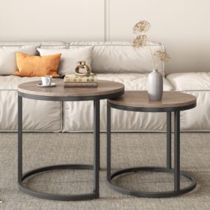 Nested Coffee Tables Separated Next To A Living Room Couch With Decor